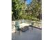 Outdoor deck featuring a table and four chairs surrounded by lush green trees at 1704 Delaware Ave, Durham, NC 27705