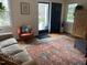 Bright entryway featuring hardwood floors, vintage rug, and views of the front porch at 1704 Delaware Ave, Durham, NC 27705