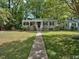 Charming single-story home with a welcoming front porch and lush green lawn at 1704 Delaware Ave, Durham, NC 27705