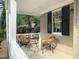 Cozy front porch with wicker chairs and table, perfect for relaxing outdoors at 1704 Delaware Ave, Durham, NC 27705