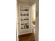 Charming hallway with built-in shelving, connecting to a brightly lit living space at 1704 Delaware Ave, Durham, NC 27705