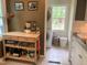 Functional kitchen with a mobile island, pantry items, and easy access to laundry area at 1704 Delaware Ave, Durham, NC 27705