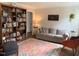 Cozy living room featuring a large bookshelf, comfortable sofa, and stylish rug at 1704 Delaware Ave, Durham, NC 27705