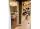 Walk-in pantry featuring shelves with jars, appliances, and dry goods, next to dining room at 1704 Delaware Ave, Durham, NC 27705