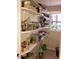 Well-stocked pantry with shelves, appliances, and natural light, perfect for organization and convenience at 1704 Delaware Ave, Durham, NC 27705