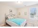Bedroom featuring a metal framed bed, side table, and natural light from the window at 174 Arrow Ln, Middlesex, NC 27557