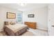 Bright bedroom featuring neutral walls, carpet floors, window, and a classic wooden dresser at 174 Arrow Ln, Middlesex, NC 27557