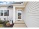 A welcoming front entryway with glass door and a small covered porch area with pleasant landscaping at 174 Arrow Ln, Middlesex, NC 27557