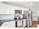 Kitchen features stainless steel appliances, white cabinets, and granite countertops at 174 Arrow Ln, Middlesex, NC 27557