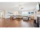 Bright living room with wood floors, fireplace, and large sectional sofa at 174 Arrow Ln, Middlesex, NC 27557