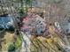 Aerial view of a charming home with a covered front porch, long driveway and mature trees at 1821 Kelly Glen Dr, Apex, NC 27502