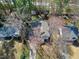 Aerial view of a charming home surrounded by mature trees with long driveway, sheds and a nice backyard at 1821 Kelly Glen Dr, Apex, NC 27502