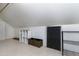 View of attic space featuring storage shelves, storage bins, and a finished floor at 1821 Kelly Glen Dr, Apex, NC 27502