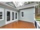A wooden deck with easy access to the house through glass doors and views of the backyard at 1821 Kelly Glen Dr, Apex, NC 27502
