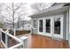A cozy back deck with wooden floors and access to the home through elegant glass doors at 1821 Kelly Glen Dr, Apex, NC 27502