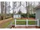 View of a backyard with a small shed, wooden fence, and plenty of trees at 1821 Kelly Glen Dr, Apex, NC 27502