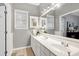 Bathroom with double vanity, large mirror reflecting the room, and neutral color scheme at 1821 Kelly Glen Dr, Apex, NC 27502