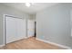 Bedroom with hardwood flooring, a ceiling fan, and a closet with bi-fold doors at 1821 Kelly Glen Dr, Apex, NC 27502