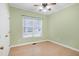 Bedroom with green walls, wood-look flooring, ceiling fan and a window with blinds at 1821 Kelly Glen Dr, Apex, NC 27502
