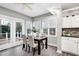 Bright dining area with views of deck, wood table, and tile backsplash on kitchen wall at 1821 Kelly Glen Dr, Apex, NC 27502