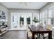 Dining area with large windows and door, wood table, and neutral color scheme at 1821 Kelly Glen Dr, Apex, NC 27502