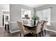 Dining room featuring a modern table and chairs, with view into the kitchen and back yard at 1821 Kelly Glen Dr, Apex, NC 27502