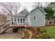View of the back of a home with a deck and landscaped yard at 1821 Kelly Glen Dr, Apex, NC 27502