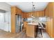 Functional kitchen featuring wood cabinetry, stainless steel appliances, and a breakfast bar at 1821 Kelly Glen Dr, Apex, NC 27502