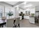 Combined kitchen and dining area featuring modern finishes, stainless steel appliances, and plenty of natural light at 1821 Kelly Glen Dr, Apex, NC 27502