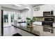 Modern kitchen with granite countertops, stainless steel appliances, and a dining area nearby at 1821 Kelly Glen Dr, Apex, NC 27502