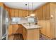 Well-lit kitchen featuring wooden cabinets, a kitchen island, and stainless steel appliances at 1821 Kelly Glen Dr, Apex, NC 27502