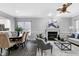 Cozy living room connected to a dining area, featuring a fireplace and contemporary furnishings at 1821 Kelly Glen Dr, Apex, NC 27502