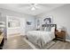 Serene main bedroom features light grey walls, modern art, a ceiling fan, and vinyl wood floors at 1821 Kelly Glen Dr, Apex, NC 27502