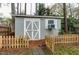 Well-kept shed surrounded by a wooden fence and stone pathway in the backyard at 1821 Kelly Glen Dr, Apex, NC 27502