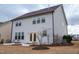 A view of the home's backyard and exterior, featuring manicured landscaping and neutral siding at 1913 Brodgen Ln, Durham, NC 27703