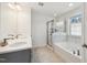 Stylish bathroom with a double sink vanity, separate shower, and tub with marble accents, all elegantly designed at 1913 Brodgen Ln, Durham, NC 27703