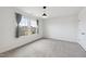 Comfortable bedroom with plush carpeting, neutral walls, and large windows framed by gray curtains, filled with natural light at 1913 Brodgen Ln, Durham, NC 27703