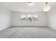 Bright bedroom with plush gray carpeting, and large windows offering serene views and allowing abundant natural light at 1913 Brodgen Ln, Durham, NC 27703