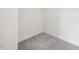 Walk-in closet with plush carpeting and white walls, offering ample space for storage and organization in this new home at 1913 Brodgen Ln, Durham, NC 27703