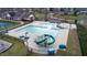 An aerial view of the community pool area, complete with slides, tables, and covered canopies at 1913 Brodgen Ln, Durham, NC 27703