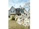 Two-story home with stone accents and white flowering tree in the front yard at 1913 Brodgen Ln, Durham, NC 27703
