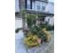 Charming two-story home featuring a landscaped front yard with pink roses, a security sign, and a stone and siding facade at 1913 Brodgen Ln, Durham, NC 27703