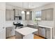 Modern kitchen with stainless steel appliances, gray cabinets, and a stylish central island at 1913 Brodgen Ln, Durham, NC 27703