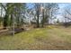 Spacious backyard featuring a swing set and mature trees, offering a serene outdoor space at 1917 Bivins St, Durham, NC 27707