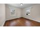 Cozy bedroom features hardwood floors, neutral paint, and two windows at 1917 Bivins St, Durham, NC 27707