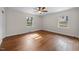 Spacious bedroom with hardwood floors, neutral paint and dual windows for natural light at 1917 Bivins St, Durham, NC 27707