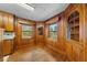 Inviting dining area with wood paneling, hardwood floors, and built-in corner cabinets at 1917 Bivins St, Durham, NC 27707