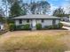 Charming single story home with fresh gray paint, manicured bushes, and a well-kept lawn at 1917 Bivins St, Durham, NC 27707