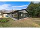 Backyard view of the home showing sunroom with large windows and access to the back yard at 1917 Bivins St, Durham, NC 27707