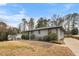 Cozy one-story home with a well-kept lawn, mature trees and driveway at 1917 Bivins St, Durham, NC 27707